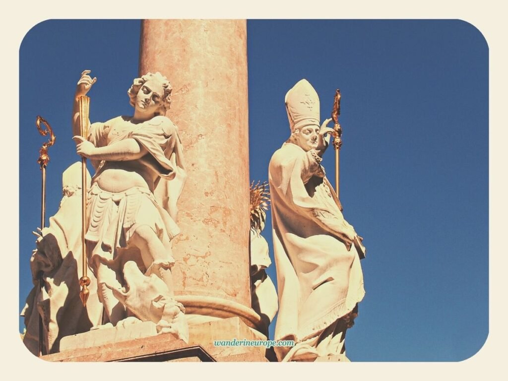 A Self Guided Tour to Old Town Innsbruck's Notable Landmarks 14 The sculptures of 4 saints at the base of Annasaule along Maria-Theresien-Straße, Old Town Innsbruck, Austria
