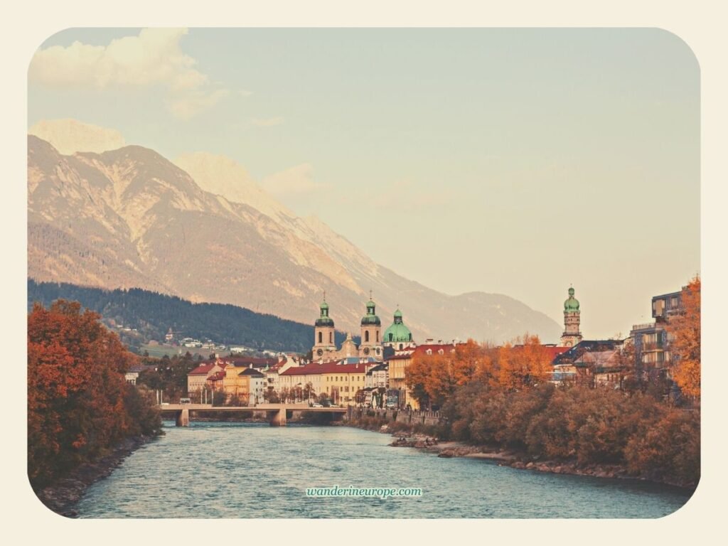 Spend 2 Days In Innsbruck, Austria (a Budget Itinerary) 31 Golden hour view of Old Town and Nordkette along the Inn River, a simple beautiful sight to see on a 2-day trip to Innsbruck, Austria