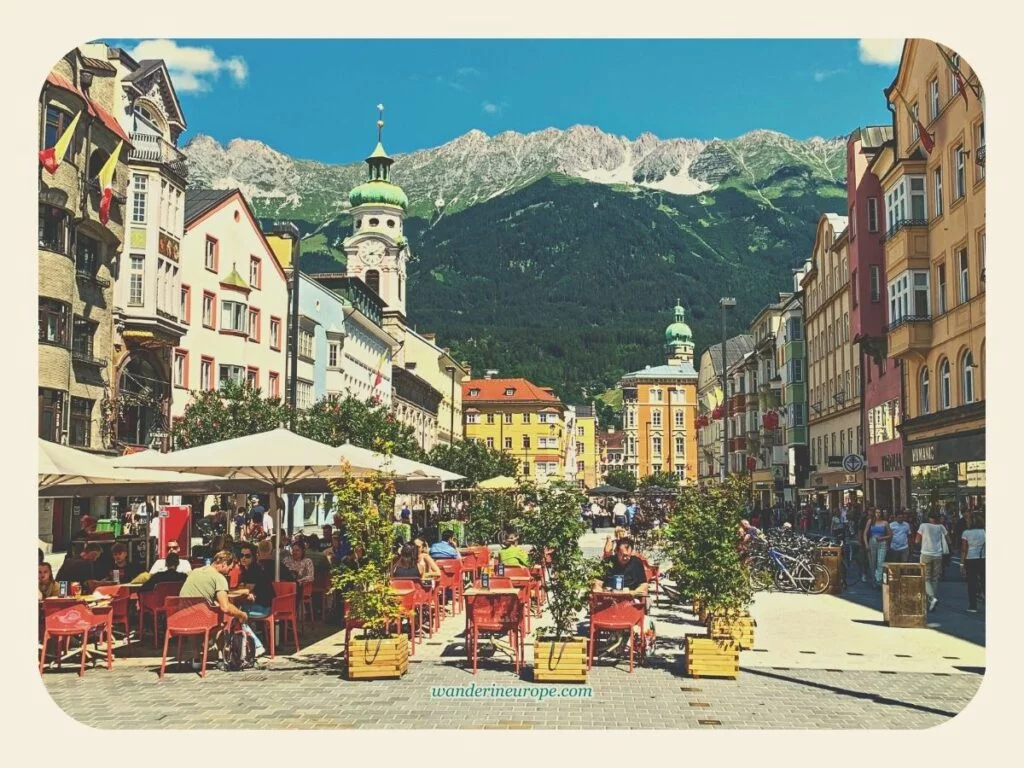 The unique eye-pleasing city view (beautiful architecture + majestic mountains) from Maria-Theresien-Straße, Innsbruck, Austria