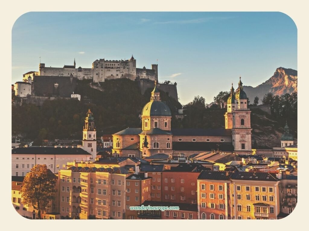 Golden hour view of Salzburg Cathedral dominating the skyline of Old Town Salzburg together with Hohensalzburg Fortress, Salzburg, Austria