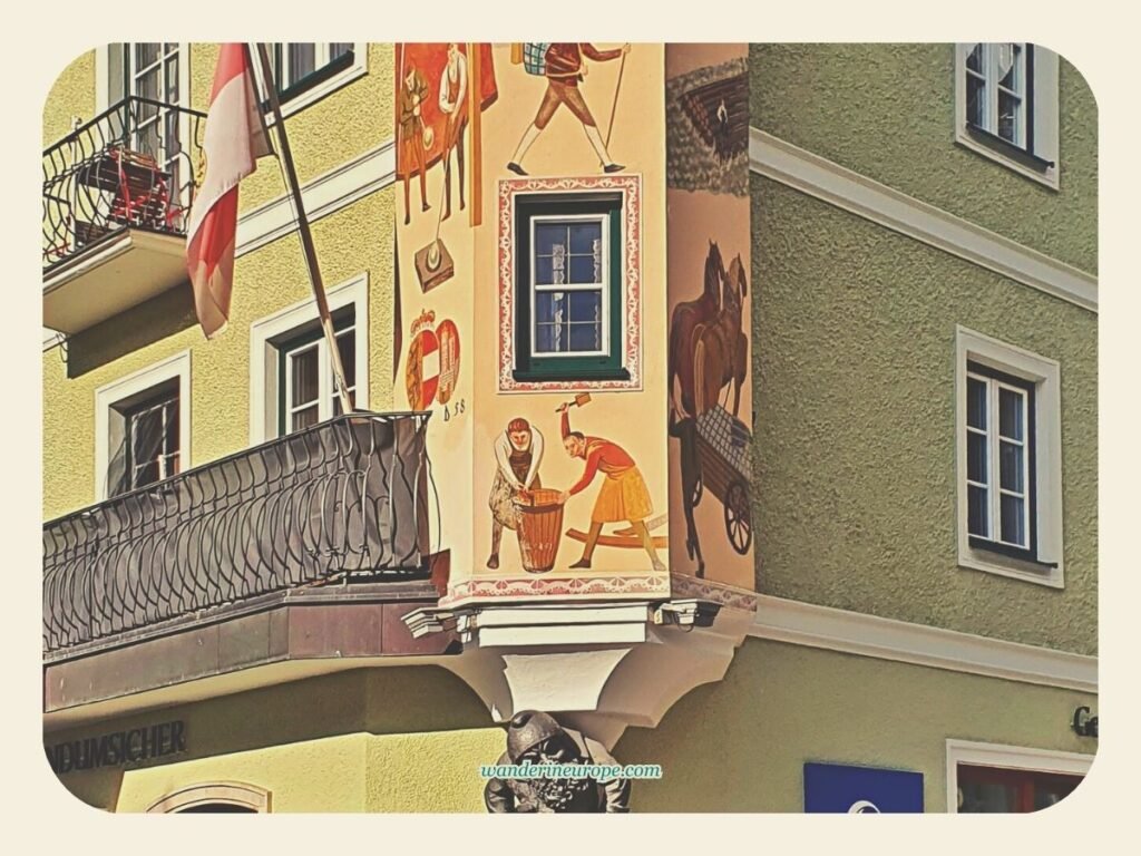 7 Attractions to See and Experience When Visiting St. Gilgen 8 More murals of the corner tower (lower part) in Mozartplatz in St. Gilgen, Salzburg, Austria