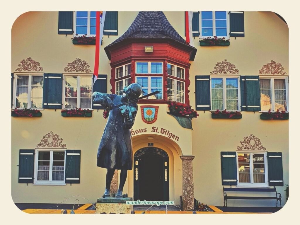 7 Attractions to See and Experience When Visiting St. Gilgen 10 The statue of Mozart in front of St. Gilgen Town Hall’s facade, Salzburg, Austria