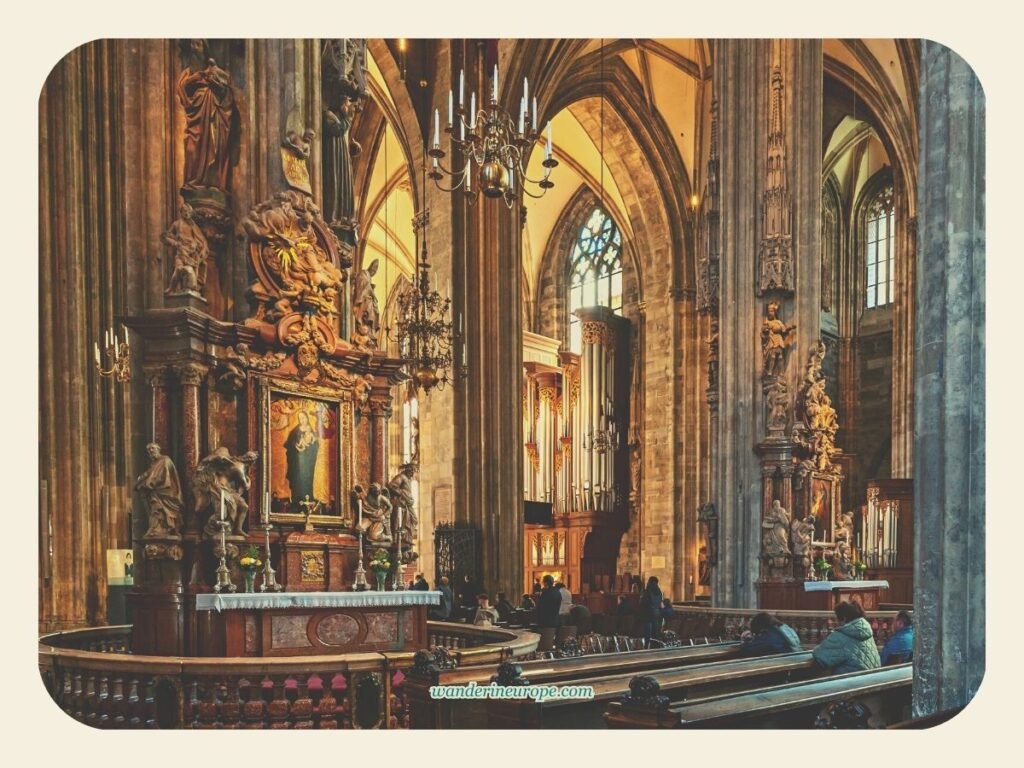 Catholics drawing spiritual inspiration from the likeness of the saints while praying in Saint Stephen’s Cathedral, Vienna, Austria