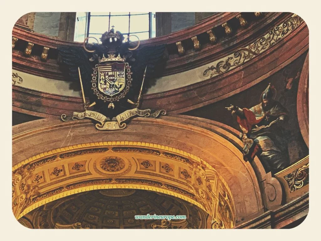 The coat of arms of the Habsburgs at the pendentive of Peterskirche, Vienna, Austria