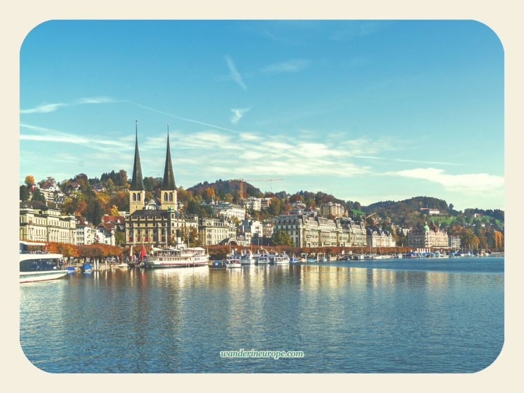 Visiting Hofkirche Lucerne (Why Go, Expectations, & Tips) 3 View of Church of St. Leodegar from a boat ride in Lake Lucerne, Switzerland