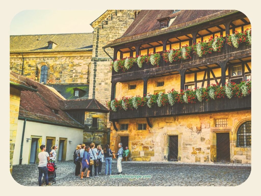 Exploring Old Town Bamberg: Must-See Sights and Experiences 19 A group of tourists checking out Alte Hofhaltung, Bamberg, Germany