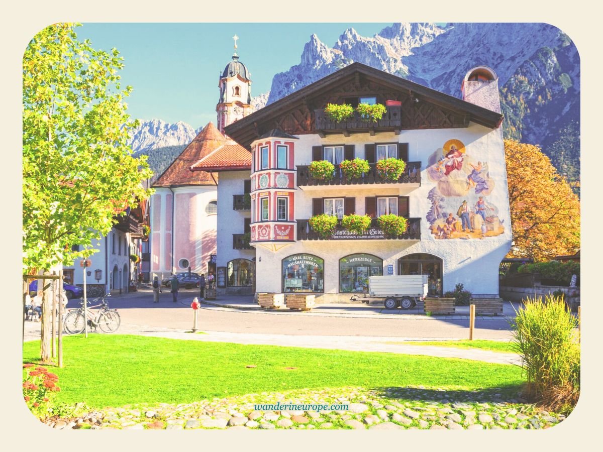 Your Guide to 10 Things to Do in Mittenwald, Bavarian Alps 7 The iconic mural-adorned house with the Karwendel mountains in the backdrop in Mittenwald, Germany