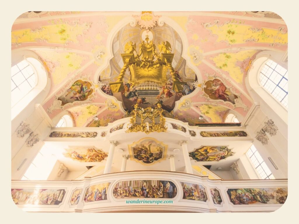 Oberammergau's Architectural Gem: St. Peter and Paul Church 8 The spectacular gallery and the organ fresco of the Church of Saint Peter and Paul in Oberammergau, Germany