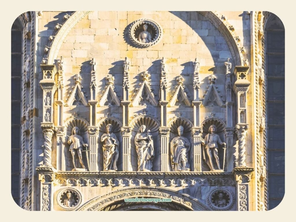Beautiful Gothic ornaments on the facade of Cattedrale di Santa Maria Assunta in Como, Lake Como, Italy